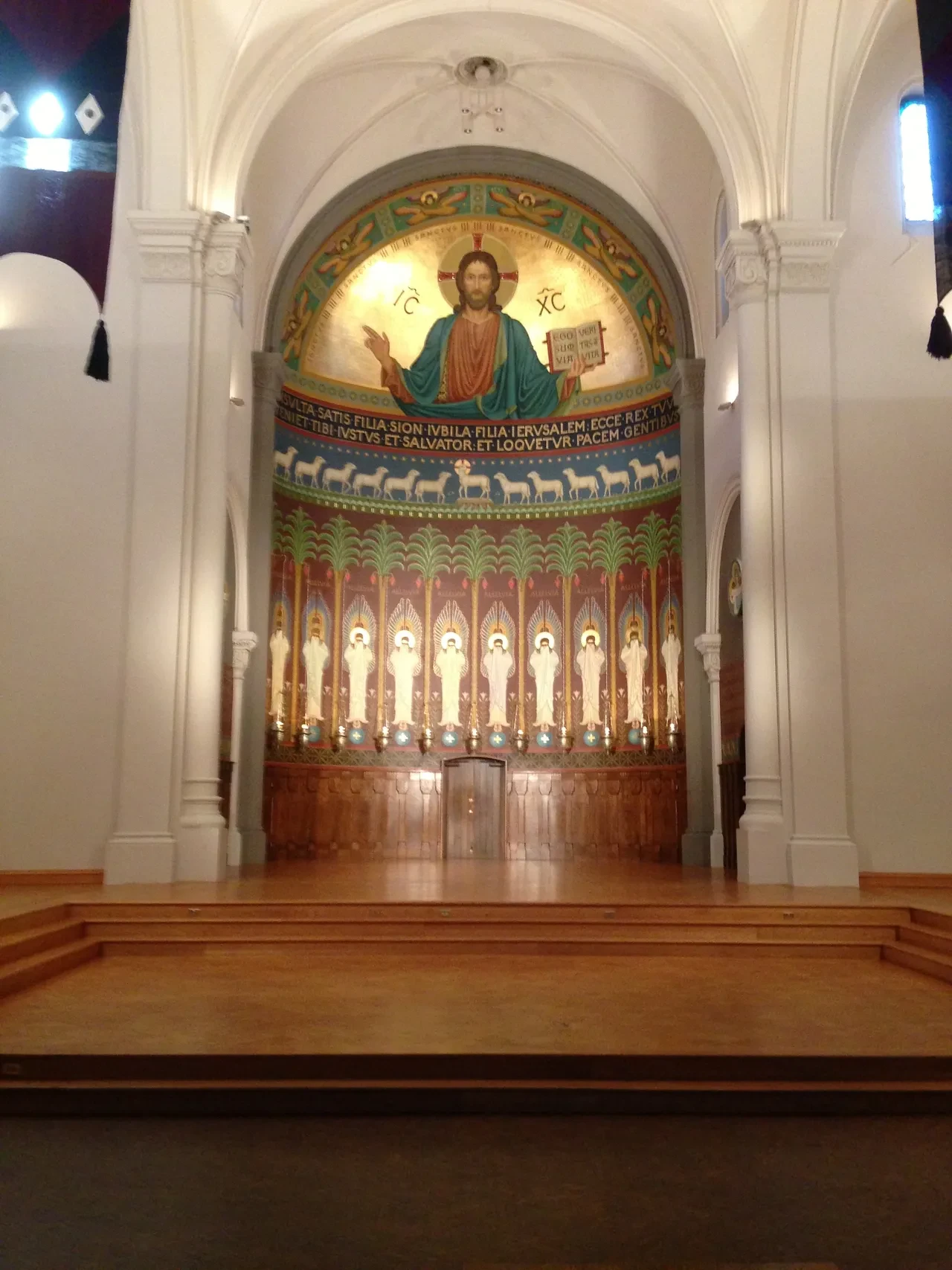 Byzantine mosaic apse with Christ Pantocrator and saints in a church sanctuary