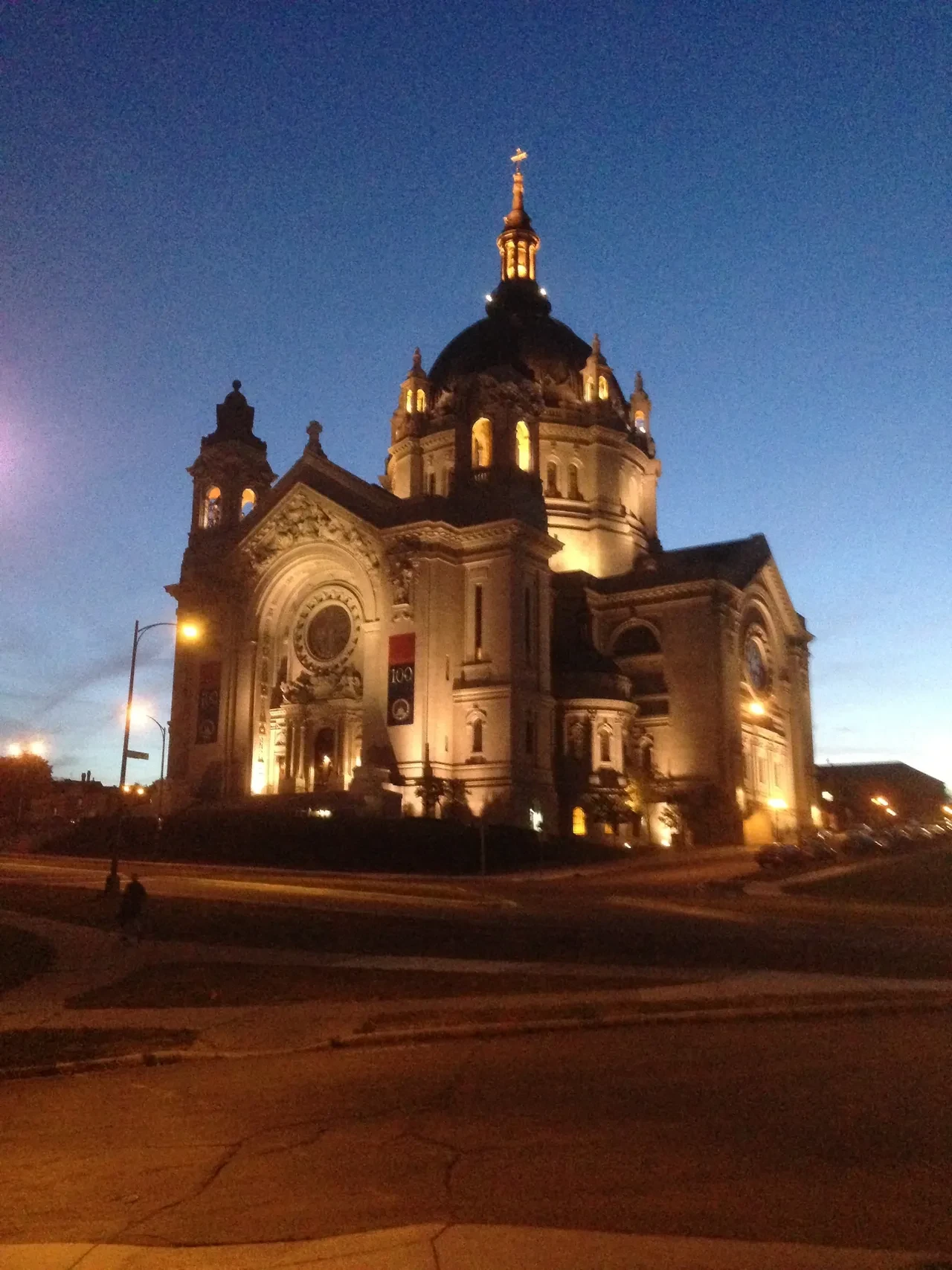 Cathedral of Saint Paul illuminated at dusk against a deep blue sky