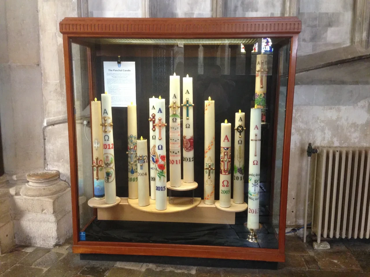Paschal candles displayed in church cabinet